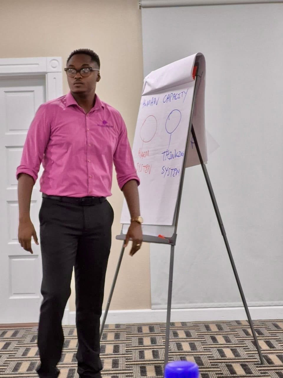 Khalid Courtney beside a Human Capacity flipchart